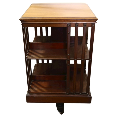 384 - An Edwardian mahogany revolving bookcase, height 86cm, 50cm Sq