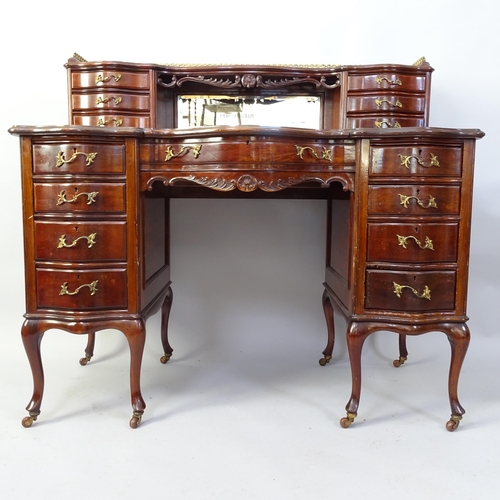 2042 - A  mahogany writing desk, with tooled and embossed green leather skiver, raised mirrored back and 15... 