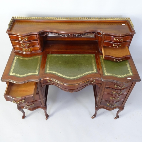 2042 - A  mahogany writing desk, with tooled and embossed green leather skiver, raised mirrored back and 15... 