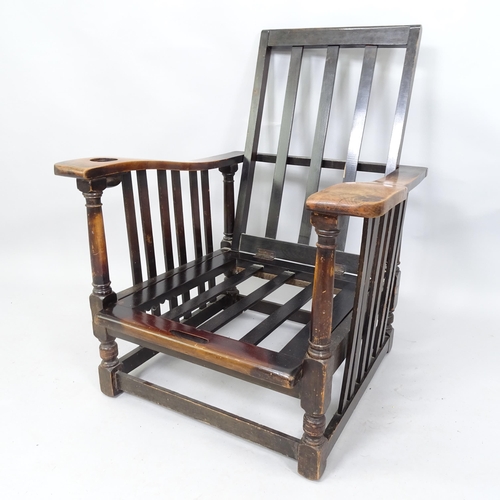 2063 - An Oak Arts and Crafts style reclining armchair. 74 x 92 x 74cm.