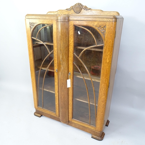 2066 - A 1930s Art Deco oak bookcase with two glazed doors and three adjustable shelves. 92cm x 135cm x 35c... 