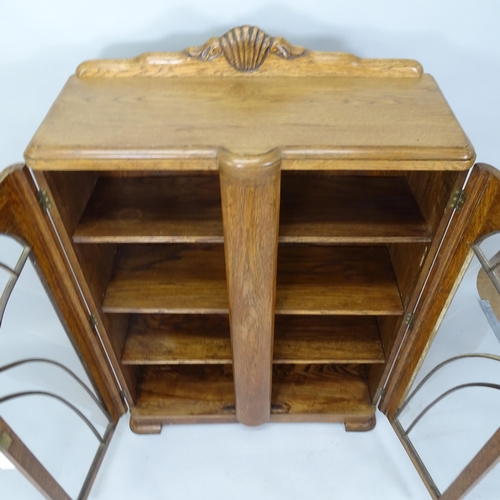 2066 - A 1930s Art Deco oak bookcase with two glazed doors and three adjustable shelves. 92cm x 135cm x 35c... 