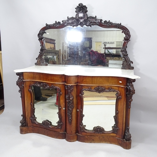 2075 - A 19th Century mahogany credenza of serpentine form, with raised mirrored back marble top, two mirro... 