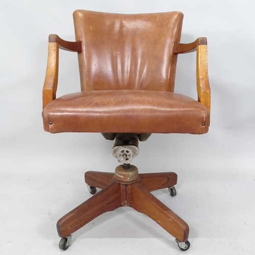 2081 - A 20th century Brown leather upholstered swivel desk chair.