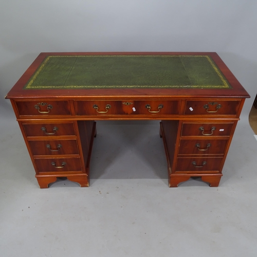 2098 - A reproduction yew wood twin-pedestal writing desk, with tooled and embossed green leather skiver, a... 