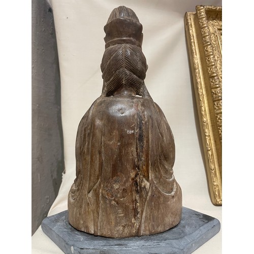 287 - An Antique Oriental carved wood Buddha, on later slate base, height 26cm