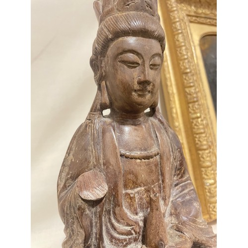 287 - An Antique Oriental carved wood Buddha, on later slate base, height 26cm