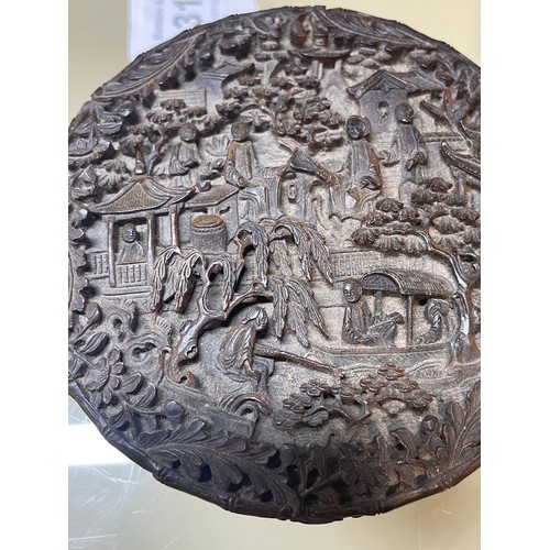 316 - A large Chinese tortoiseshell circular box, allover high relief carved landscape scenes, diameter 9.... 