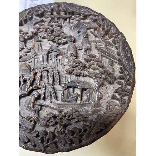 316 - A large Chinese tortoiseshell circular box, allover high relief carved landscape scenes, diameter 9.... 