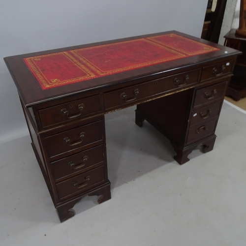 2165 - A reproduction mahogany twin-pedestal writing desk, with tooled and embossed red leather skiver, and... 