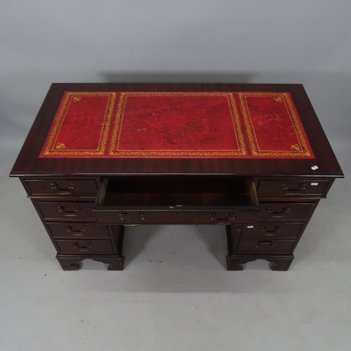 2165 - A reproduction mahogany twin-pedestal writing desk, with tooled and embossed red leather skiver, and... 