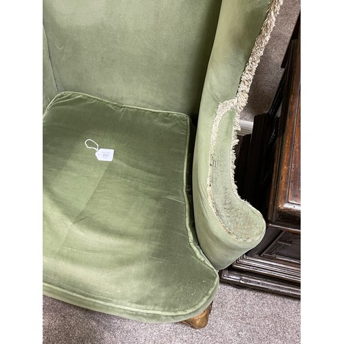 265 - A pair of 19th century upholstered wing armchairs in Queen Anne style, on walnut cabriole legs