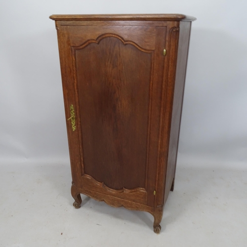 2228 - An oak Continental style music cabinet, with single panelled door and fitted interior, on cabriole l... 