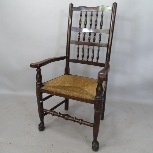 2239 - An Antique mahogany North Country style open-arm chair, with bobbin turned back and rush seat