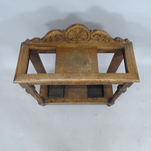 2199 - A carved oak stickstand with all over carved decoration and metal driptrays. 77cm x 88cm x 28cm.