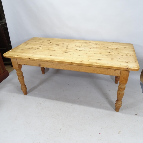 2202 - A pine farmhouse dining table on turned legs. 183cm x 77cm x 90cm