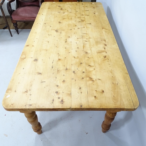 2202 - A pine farmhouse dining table on turned legs. 183cm x 77cm x 90cm