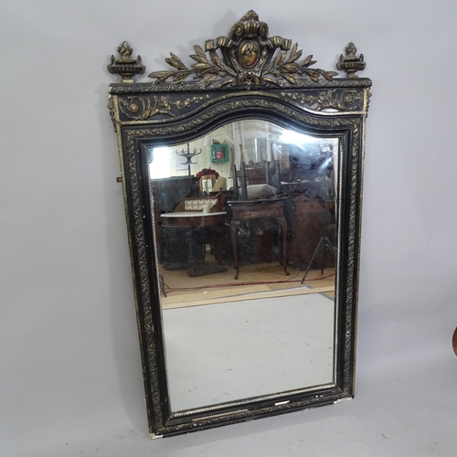 2217 - A 19th century ebony and gilt framed wall mirror with carved decoration. 94cm x 157cm