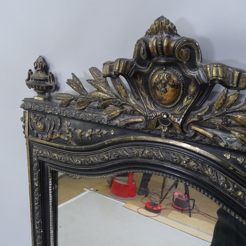 2217 - A 19th century ebony and gilt framed wall mirror with carved decoration. 94cm x 157cm