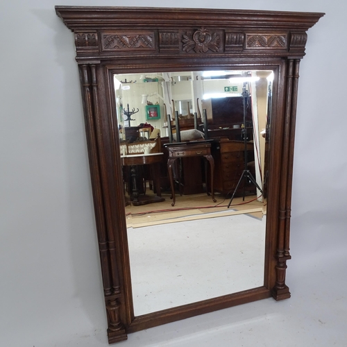 2218 - a 19th century oak framed bevel-edged over-mantle mirror with carved decoration, 98cm x 129cm