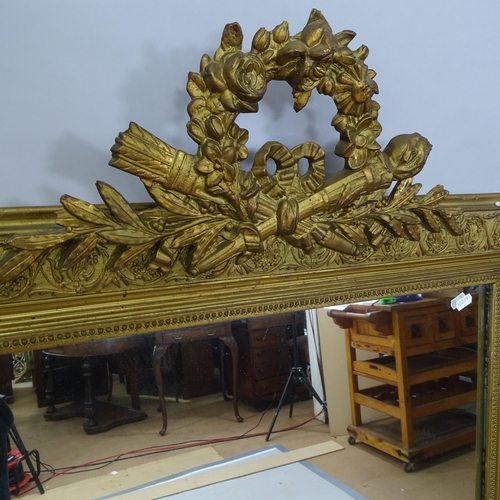 2219 - A 19th century gilt-framed wall mirror with brocade decoration. 82cm x 137cm