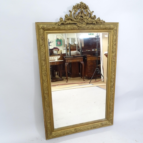 2220 - A 19th century gilt-framed wall mirror with brocade decoration. 78 x 131cm.