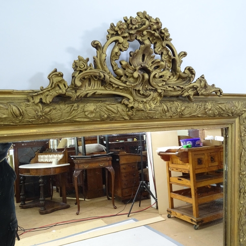 2220 - A 19th century gilt-framed wall mirror with brocade decoration. 78 x 131cm.