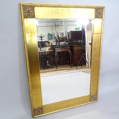 2221 - A modern gilt-framed bevel edgved wall mirror. 85cm x 115cm