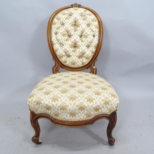 2225 - A Victorian mahogany and button-back upholstered nursing chair with carved decoration.