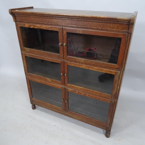 2242 - An early 20th century oak three section Minty bookcase, with maker's label. 90cm x 104cm x 27cm