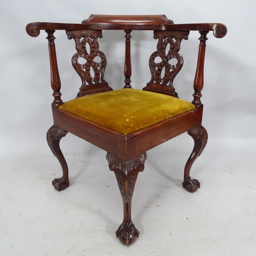 2245 - A mahogany corner armchair on cabriole legs with claw and ball feet.