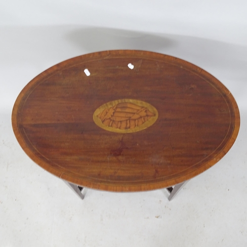 2251 - An Edwardian mahogany and satinwood strung oval two-tier occasional table, with inlaid shell decorat... 