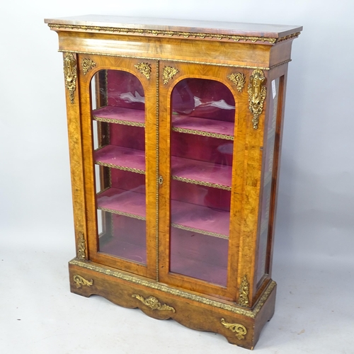 2253 - A Victorian crossbanded walnut display cabinet with two glazed panelled doors, brass ormalu mounts a... 