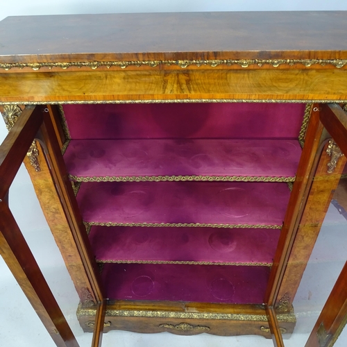 2253 - A Victorian crossbanded walnut display cabinet with two glazed panelled doors, brass ormalu mounts a... 