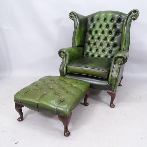 2268 - A Green leather upholstered buttoned wing back fireside armchair 89 x 106 x 80cm and a matched green... 