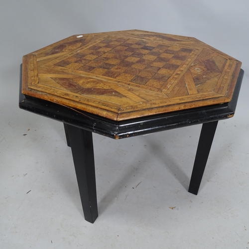 2280 - An octagonal inlaid games-top table on ebonised frame. 66cm x 46cm