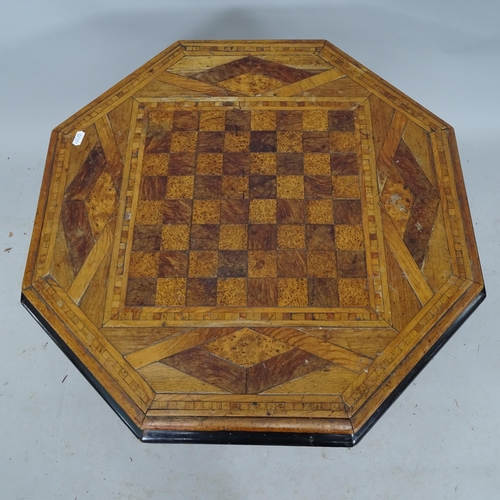 2280 - An octagonal inlaid games-top table on ebonised frame. 66cm x 46cm