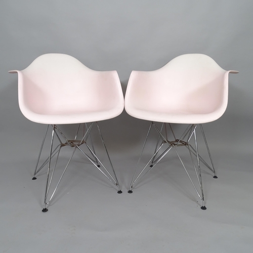 2506 - A pair of pink Eames style plastic shell armchairs on Eiffel base