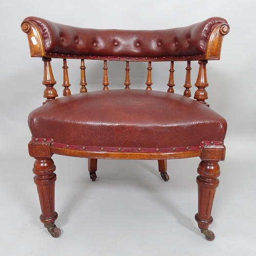 2509 - An early 20th century mahogany and red faux-leather upholstered bow arm desk chair