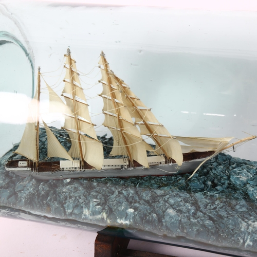 12 - A mid-century scratch-built 4-mastered tea clipper and Chinese junk presented in a tolly bottle, by ... 