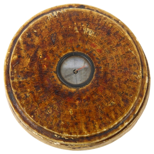 132 - A Chinese wooden-cased celestial calendar compass, diameter 10cm