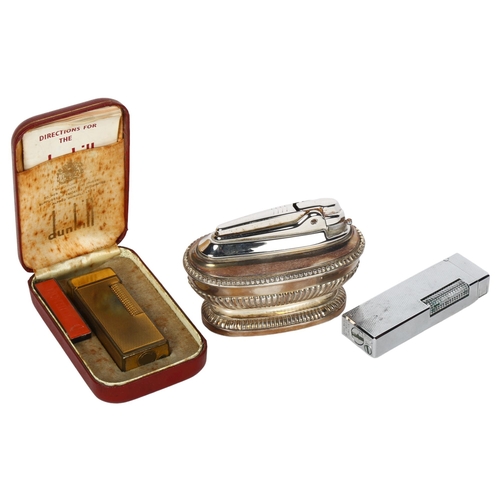 153 - A Vintage Dunhill gold plated lighter in original case, a Ronson silver plated table lighter, and a ... 