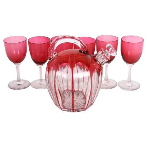 193 - A cranberry overlay crystal decanter and stopper, together with a set of 6 cranberry wine glasses