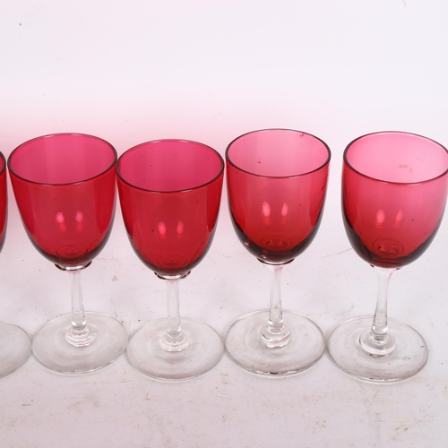 193 - A cranberry overlay crystal decanter and stopper, together with a set of 6 cranberry wine glasses