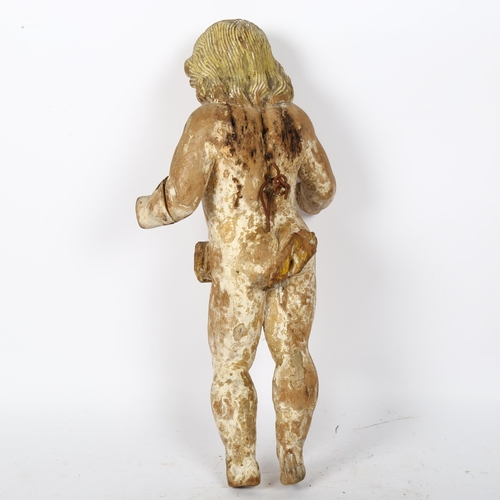 32 - A 19th century carved wood figure of a child, with traces of original paints, with hanging hook to h... 