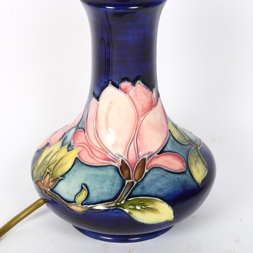 6 - MOORCROFT - a tube-lined Hibiscus decorated table lamp, height to top of bayonet fitting 25cm