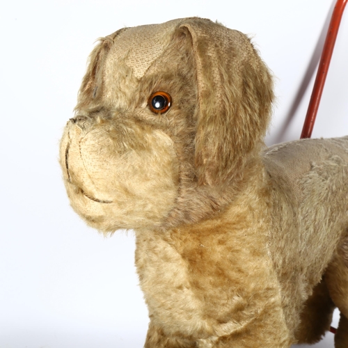 88 - A Vintage Plush covered push-along dog, by The International Model Aircraft Ltd, with label, height ... 