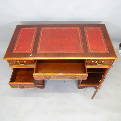 2532 - A late 20th century Waring and Gillow mahogany pedestal writing desk with inset red leather skiver a... 