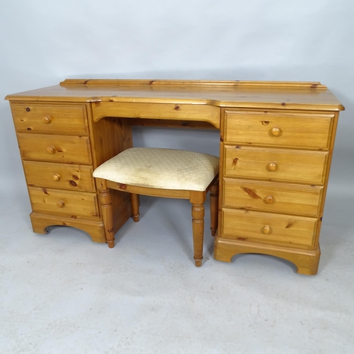 2540 - A modern pine kneehole dressing table with nine fitted drawers, 146cm x 76cm x 45cm and a matching s... 