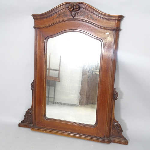 2552 - An oak arch top over-mantle mirror with carved decoration. 104cm x 116cm